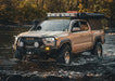 Tan 3rd gen Tacoma with a Backwoods Adventure Mods front bumper