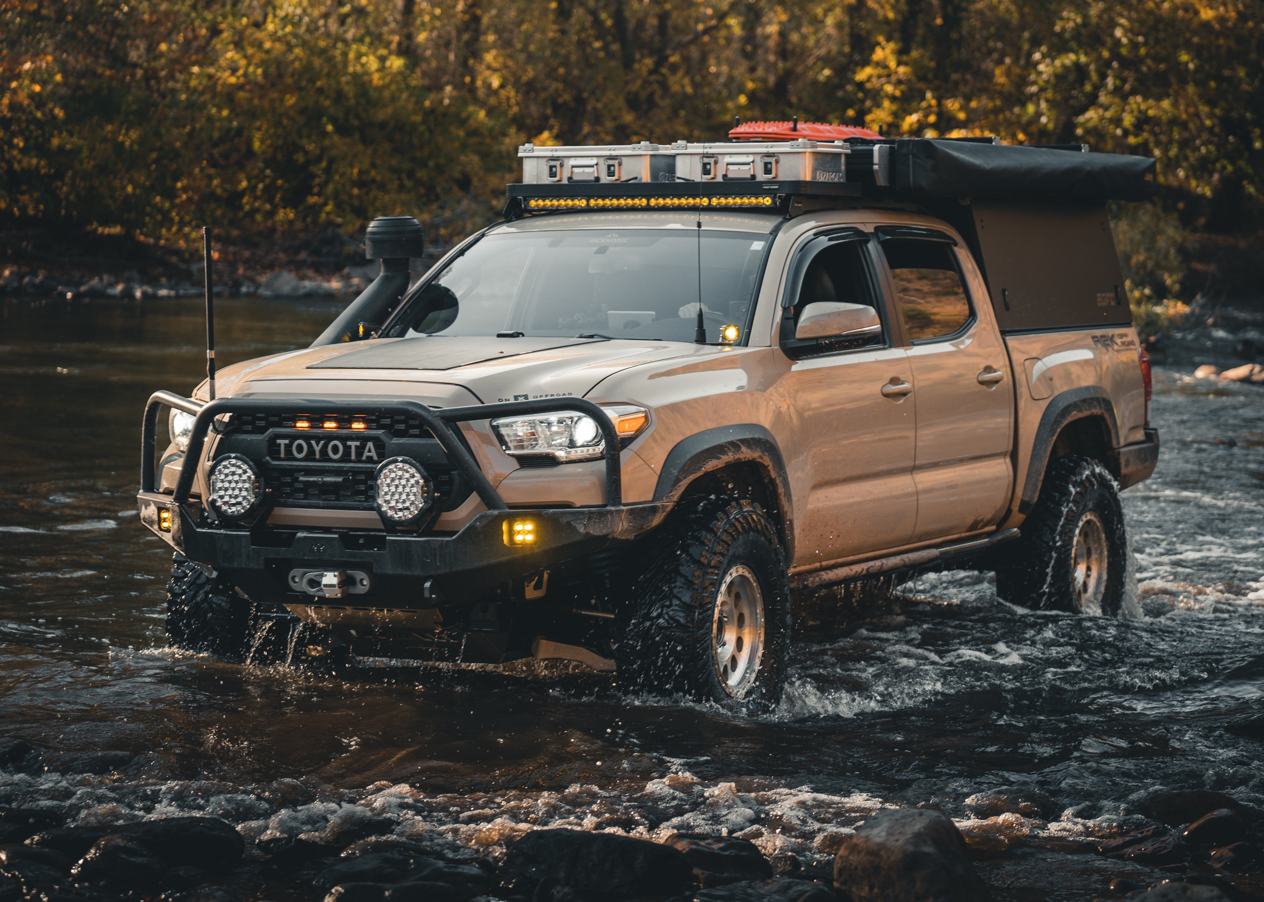 Tan 3rd gen Tacoma with a Backwoods Adventure Mods front bumper