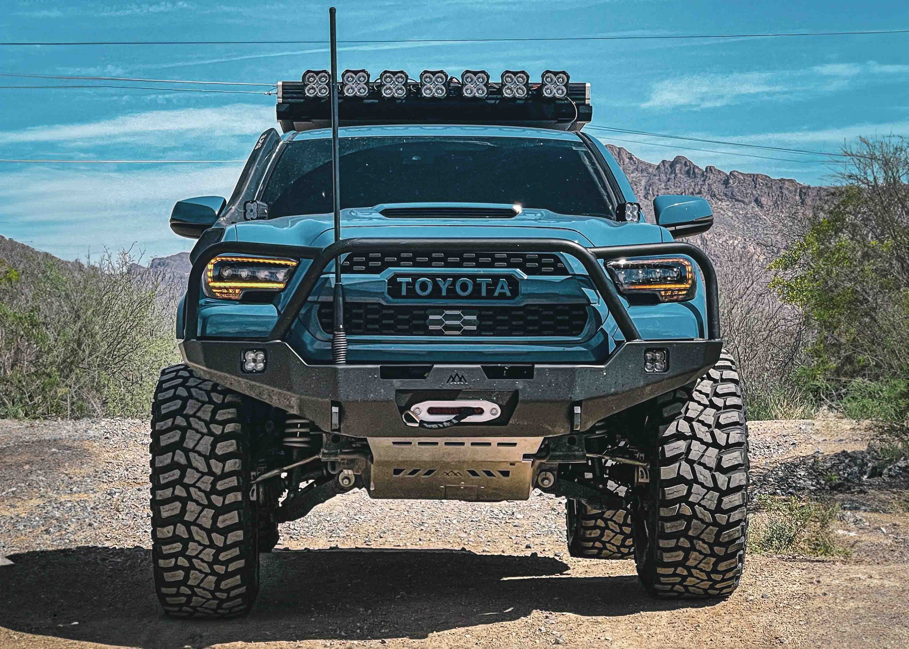 Blue 3rd gen Tacoma with Backwoods Adventure Mods front bumper