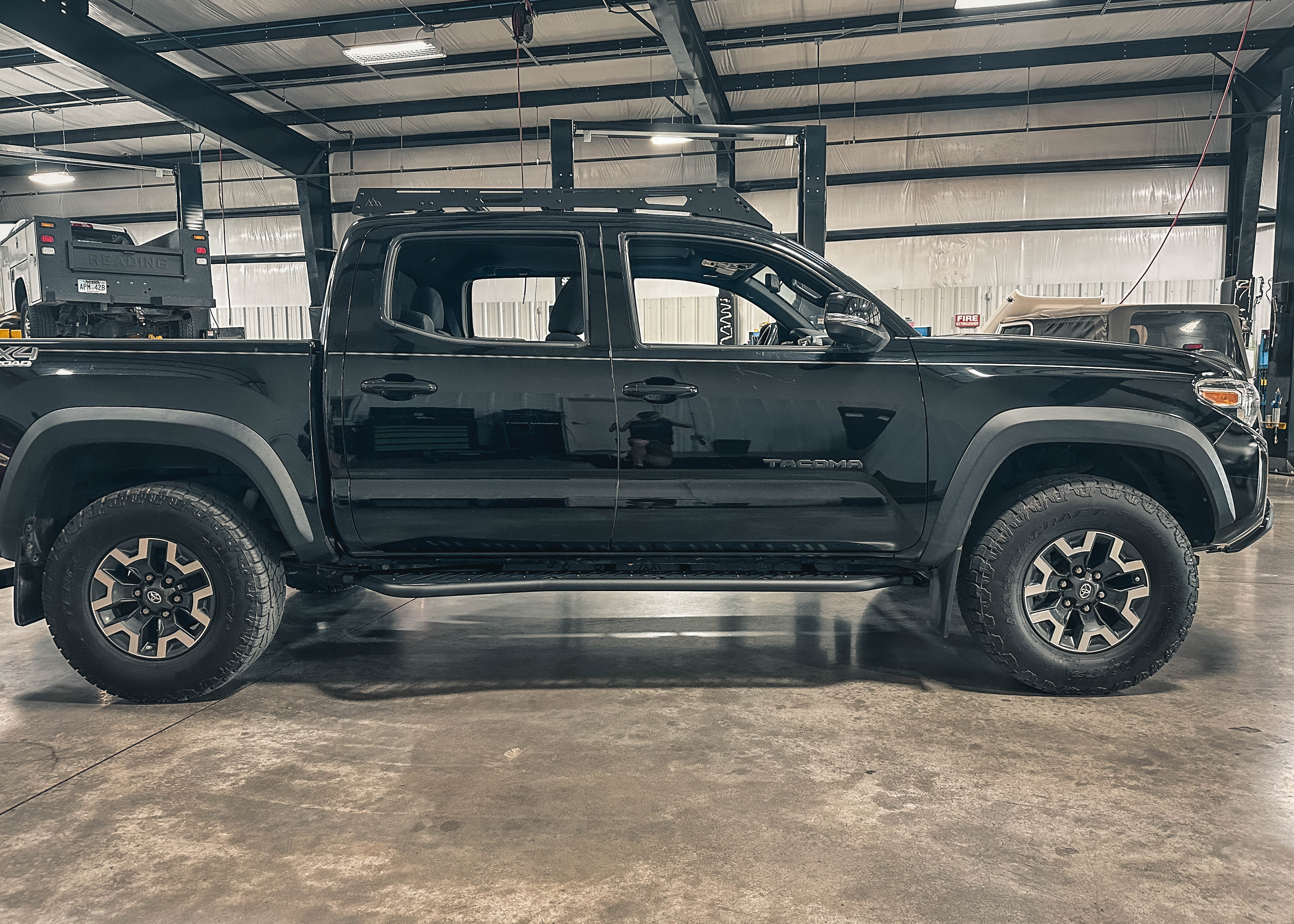 Side view of Backwoods Adventure Mods rock sliders on a 3rd gen Tacoma