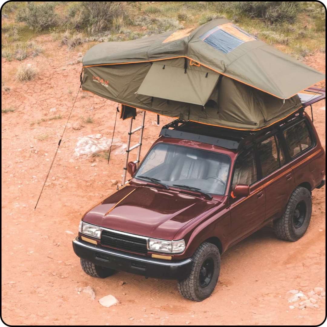 Red Land Cruiser with a Roam Adventure Company roof top tent. Perfect for overlanding.