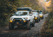 Built Toyotas lined up on an off road trail