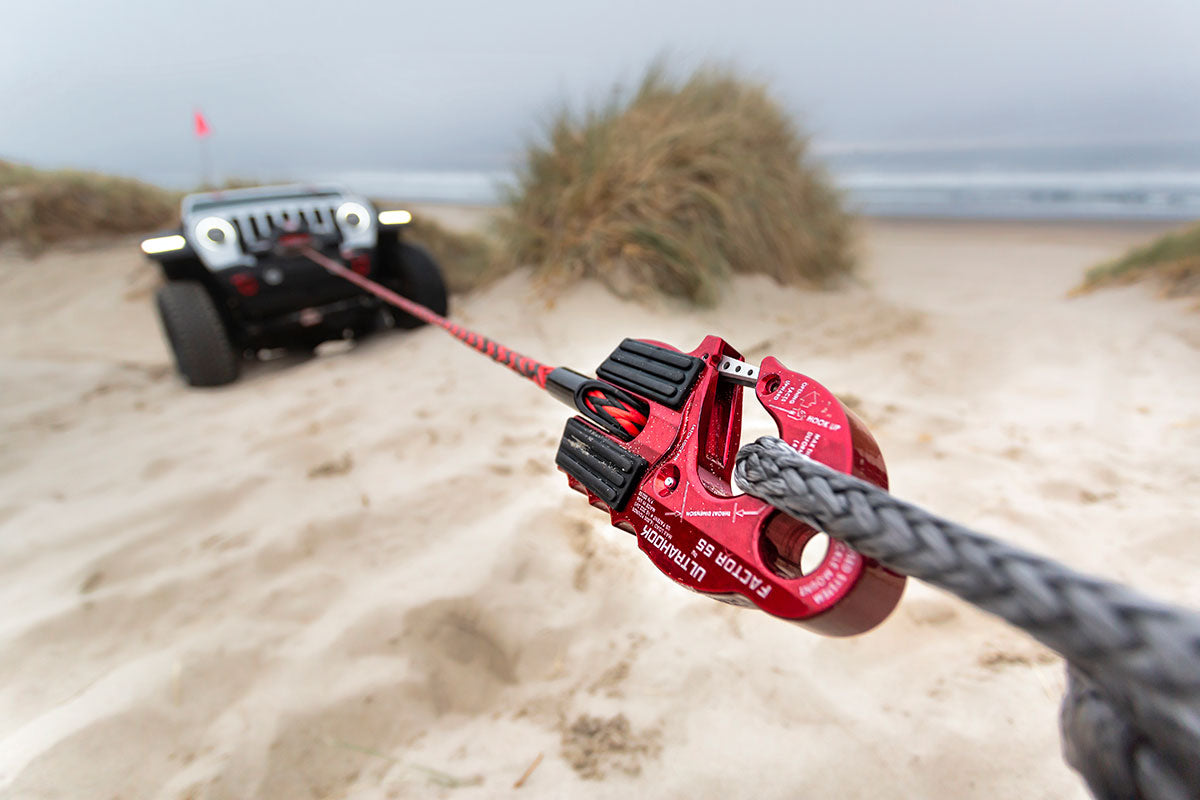 A jeep being towed using a Factor 55 Ultrahook Winch Shackle