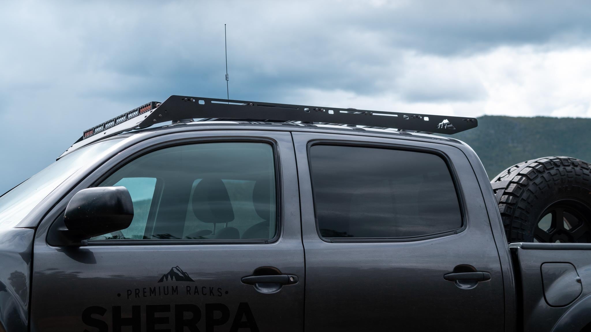 Side view of a 2nd gen Tacoma with Sherpa Grand Teton sport roof rack and light bar