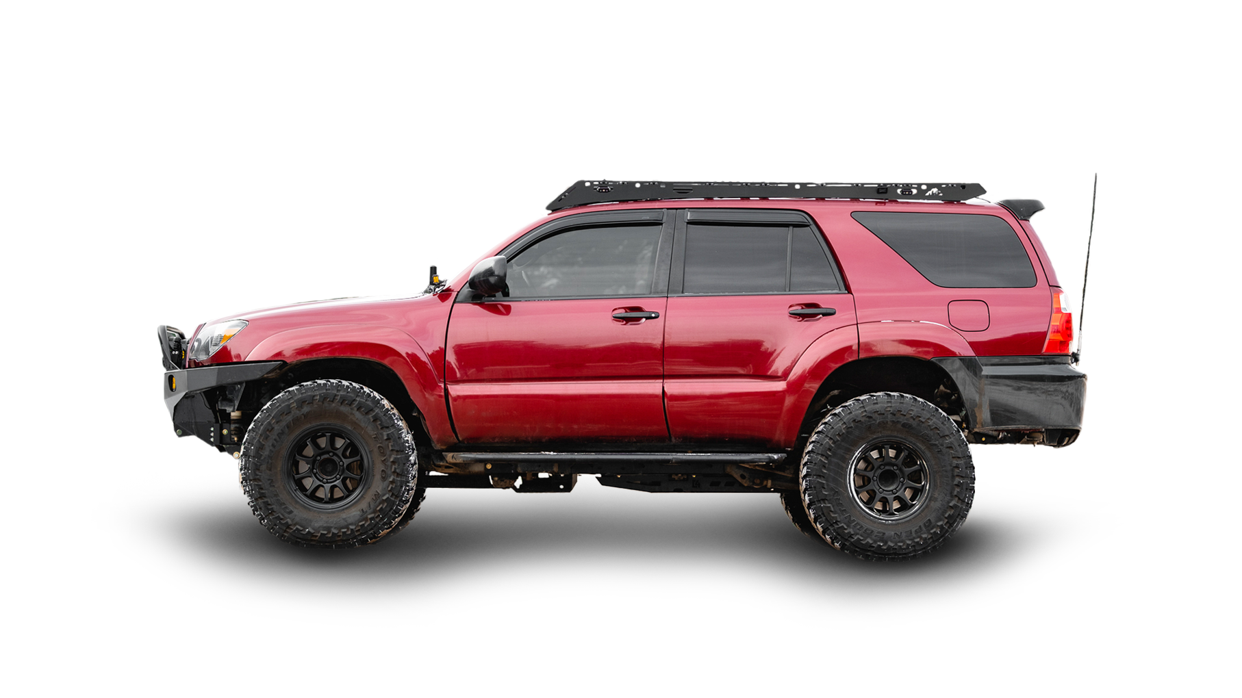 A red 4th gen 4Runner with a Sherpa Princeton roof rack and white background